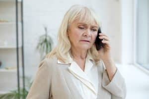 A lady is on the phone calling for help regarding a personal injury case.