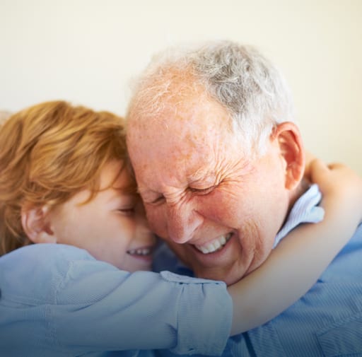 Child Hugging Elderly Man