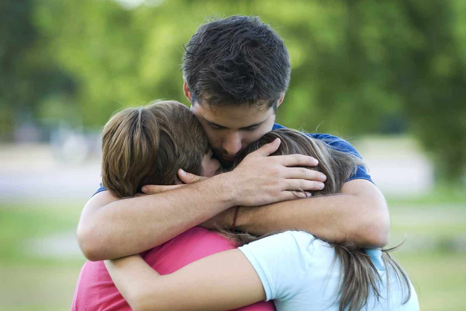 Father Consoling Children Stock Photo