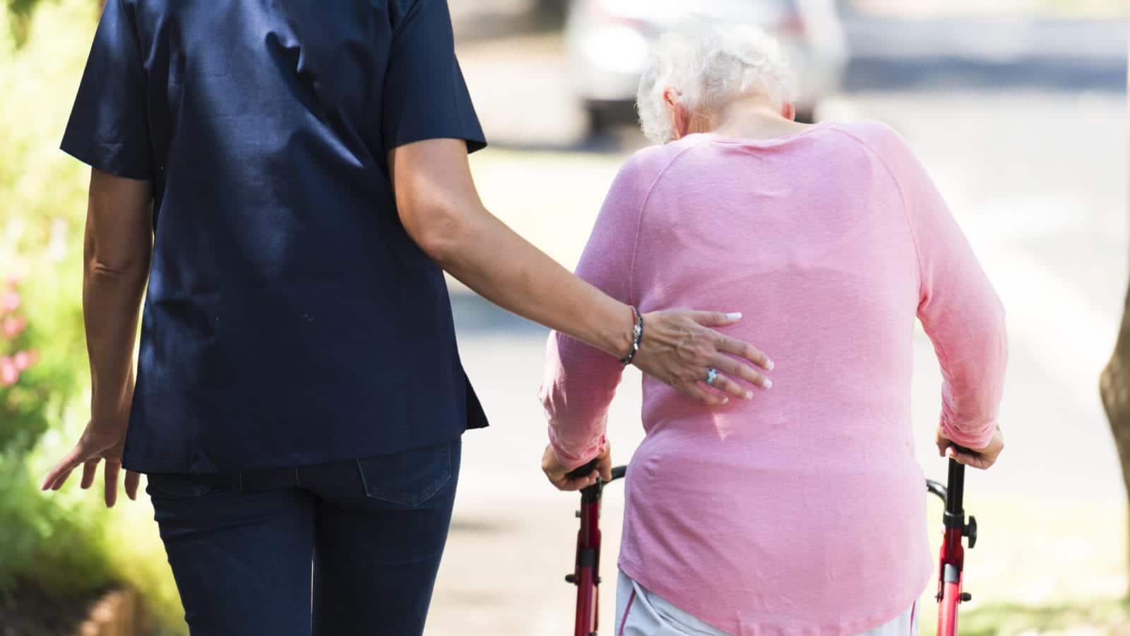 Nursing Home Staff With Elderly Woman Stock Photo