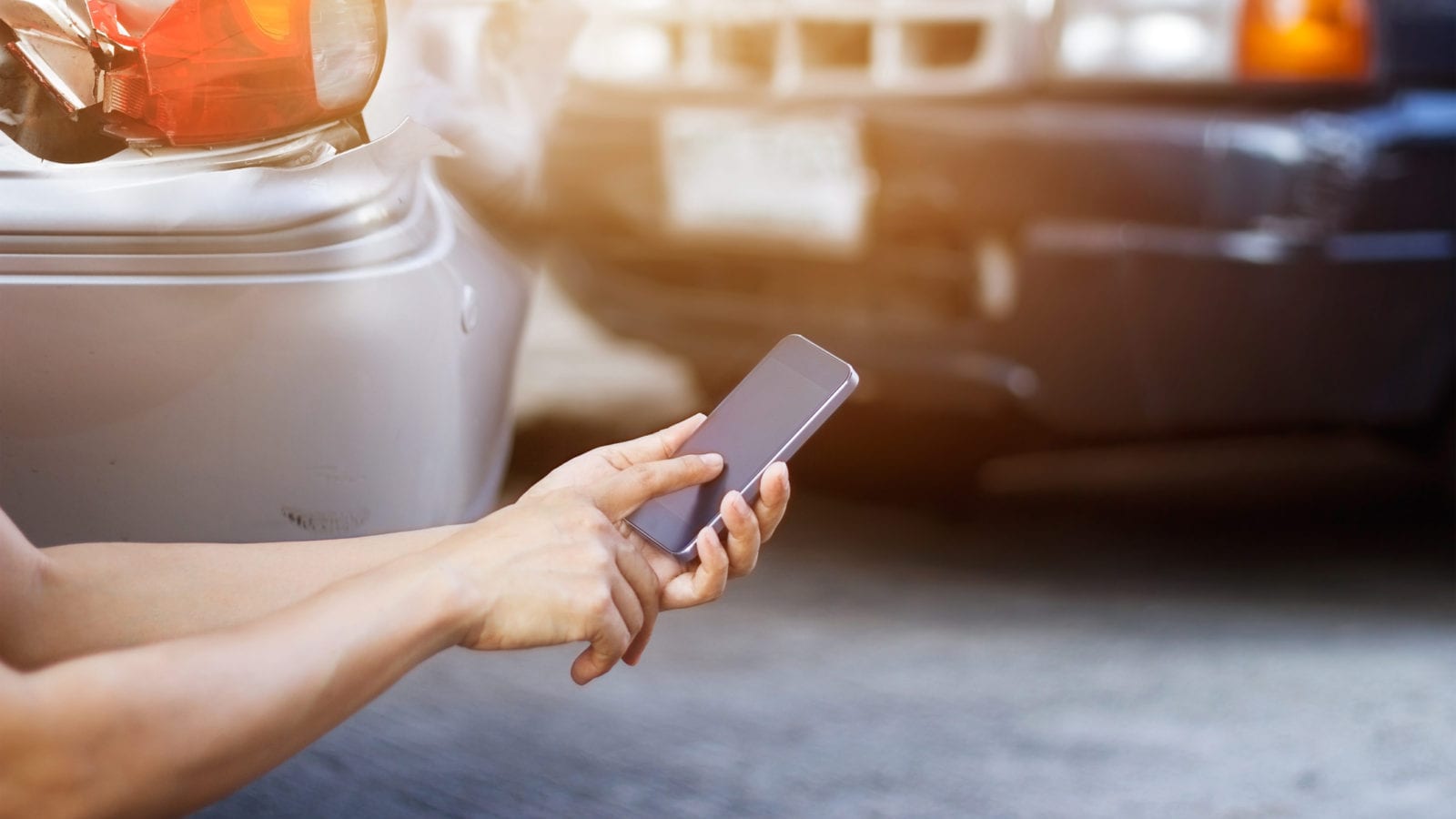 Smartphone Car Accident Stock Photo