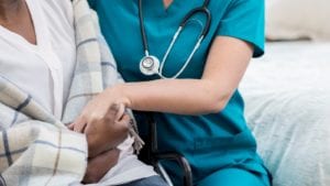 Nurse Consoling A Patient Stock Photo