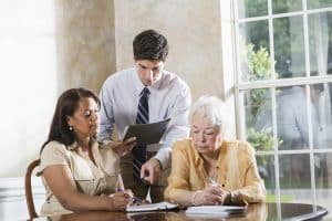 A lawyer helps an elderly client with her financial abuse lawsuit.