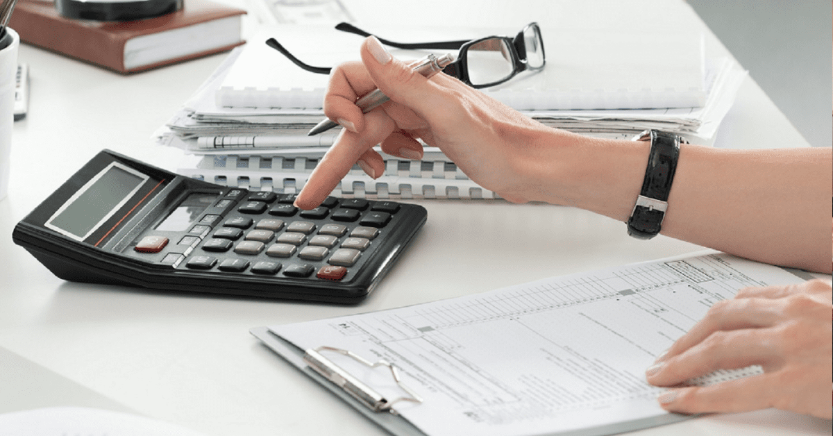 Insurance Adjuster Using A Calculator Stock Photo