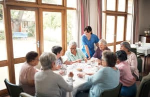 Nursing Home Residents Playing Cards At A Table