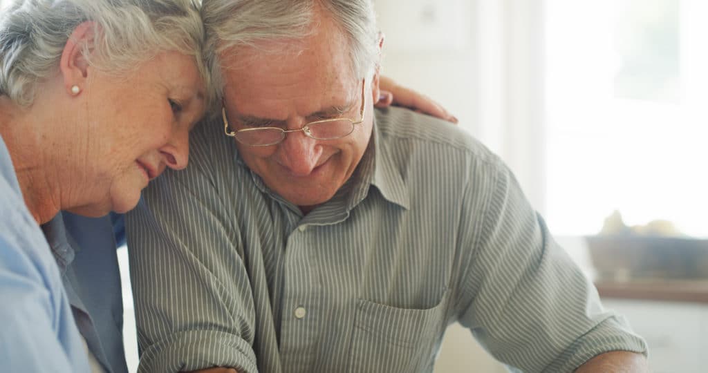 a senior couple comforting each other in their Charleston, WV, nursing home facility