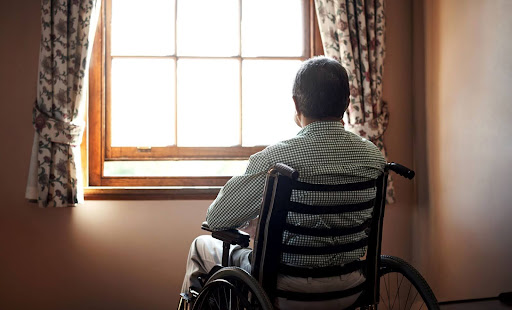 Elderly man in a wheelchair looks out his window in a Dunbar, WV, nursing home